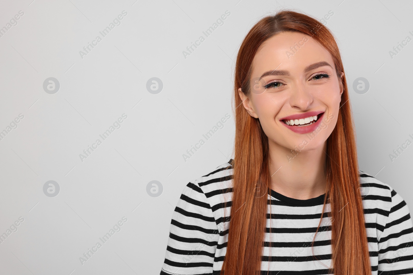 Photo of Portrait of beautiful young woman on light gray background, space for text