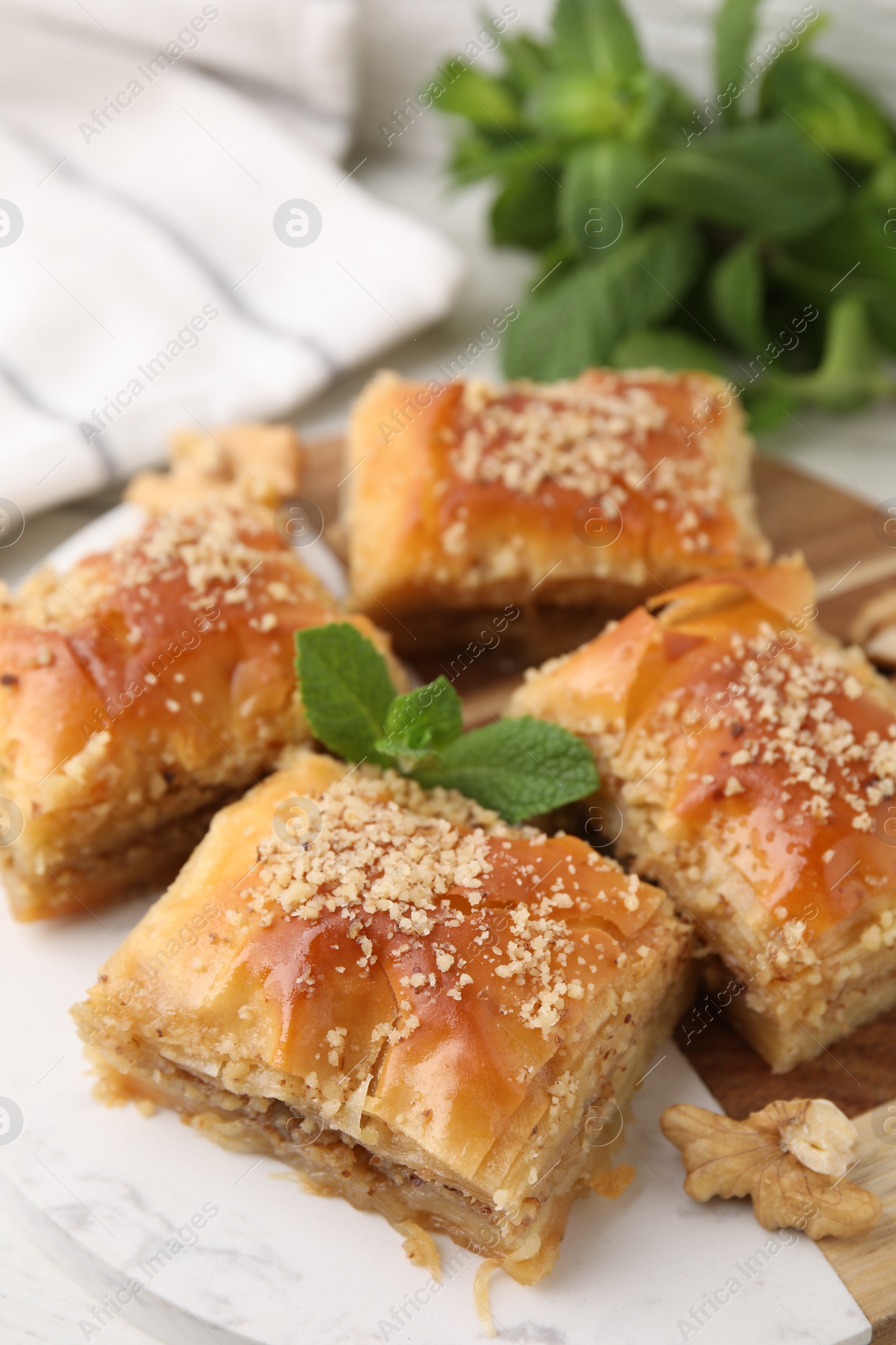 Photo of Eastern sweets. Pieces of tasty baklava on table, closeup