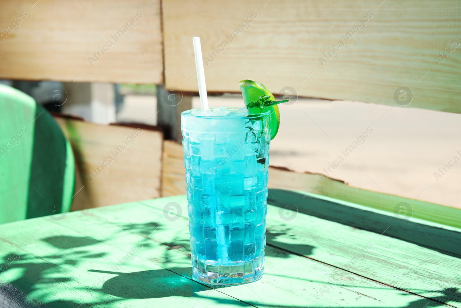 Photo of Glass with delicious cocktail on table in cafe