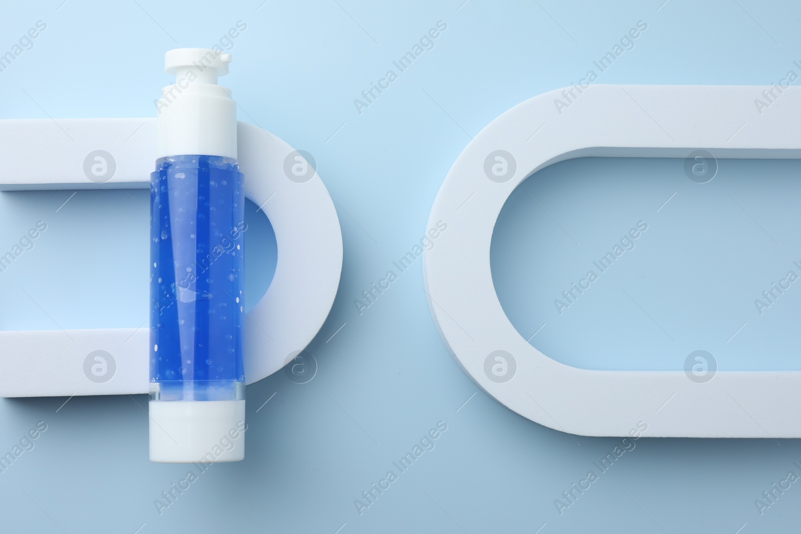 Photo of Cosmetic product on light blue background, top view