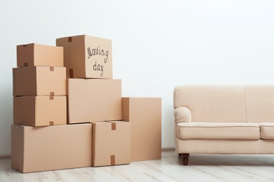 Photo of Pile of moving boxes in living room