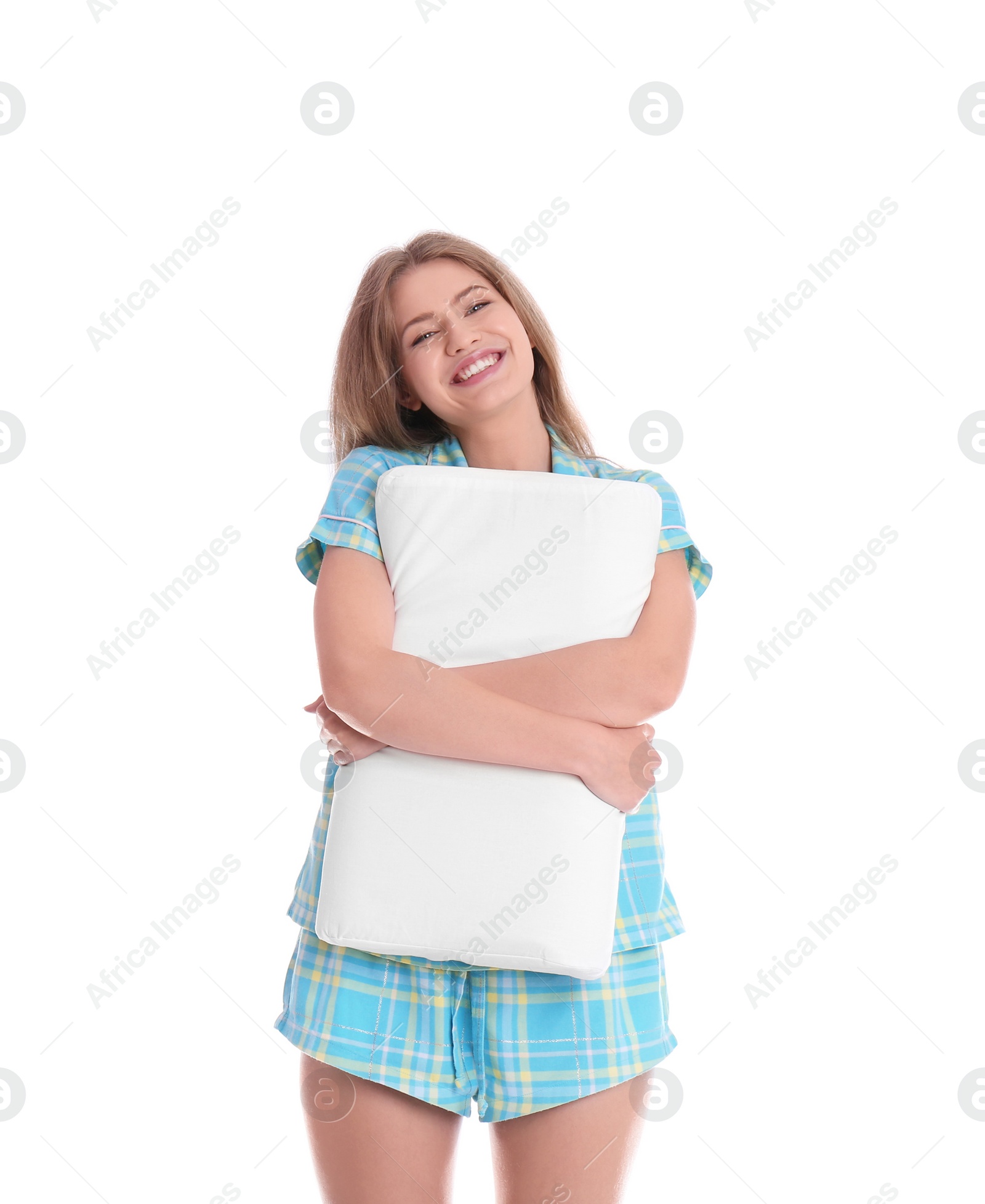 Photo of Young woman in pajamas embracing pillow on white background