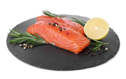 Pieces of fresh raw salmon, spices and lemon on white background