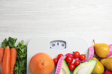 Photo of Flat lay composition with scales and healthy food on white wooden table, space for text