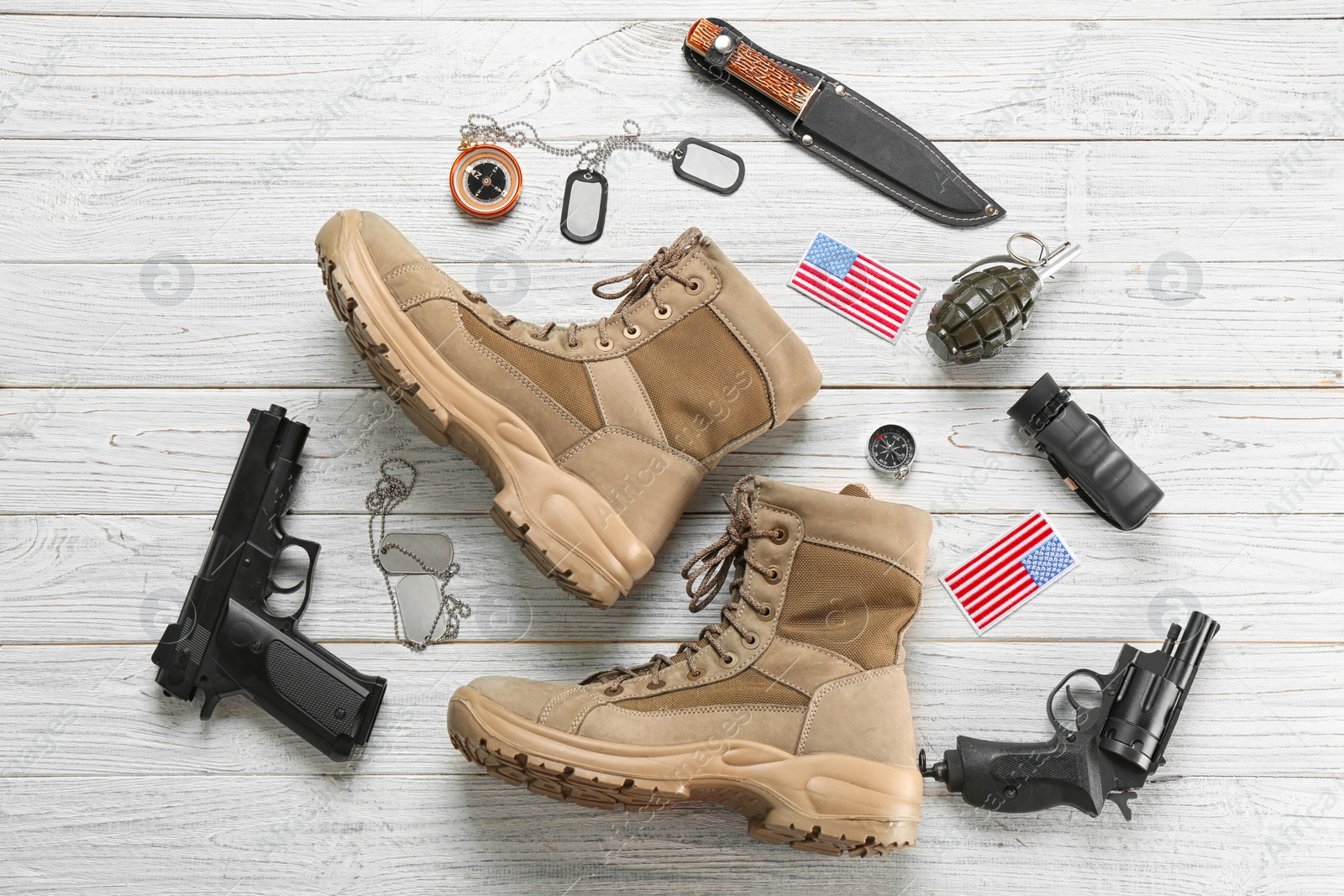 Photo of Set of military equipment and combat boots on wooden background, flat lay