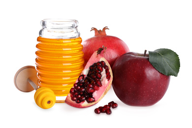 Photo of Honey, apple and pomegranates on white background. Jewish New Year (Rosh Hashanah) holiday