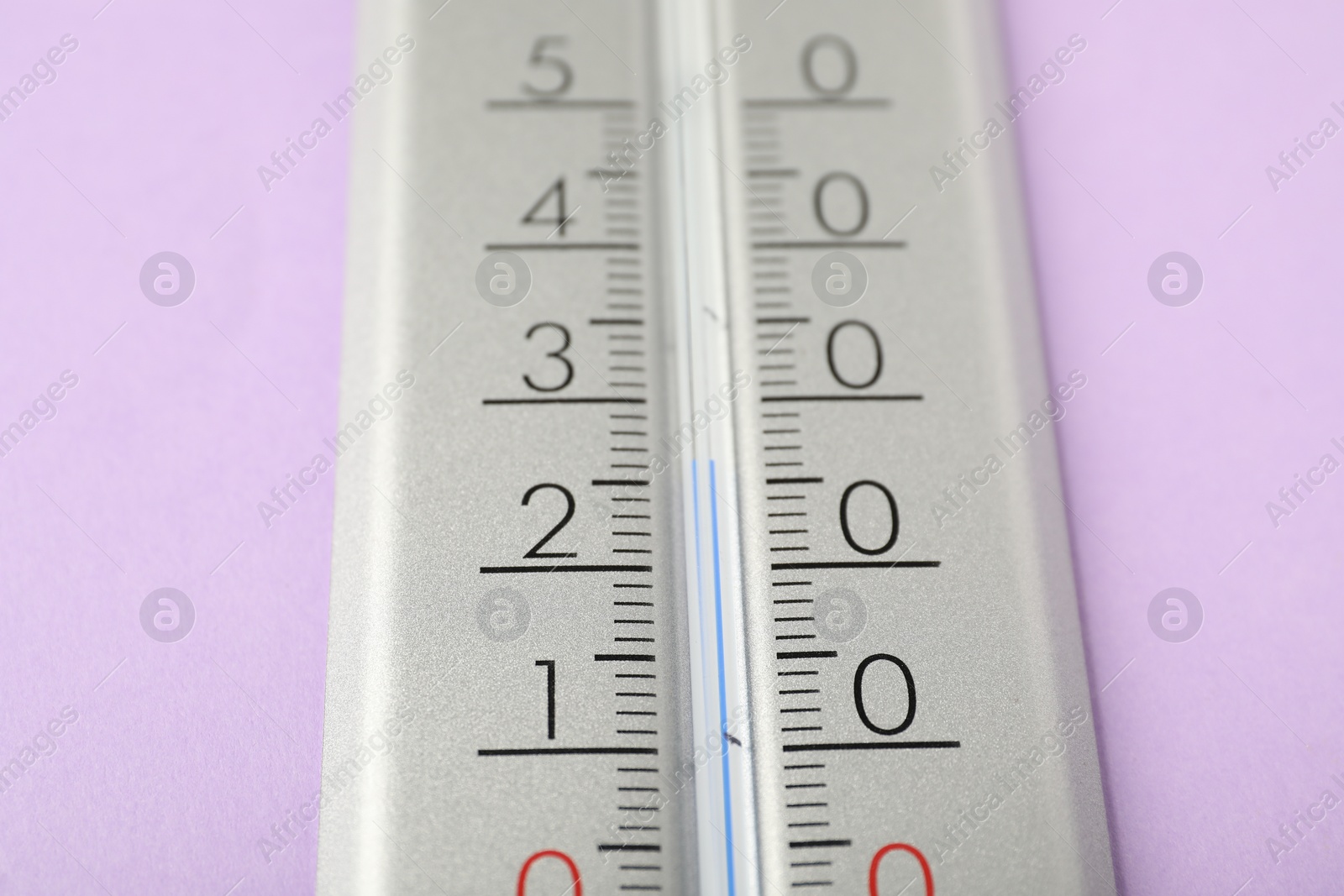 Photo of Modern weather thermometer on lilac background, closeup