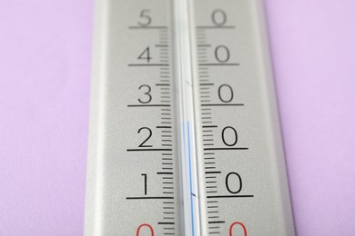 Modern weather thermometer on lilac background, closeup