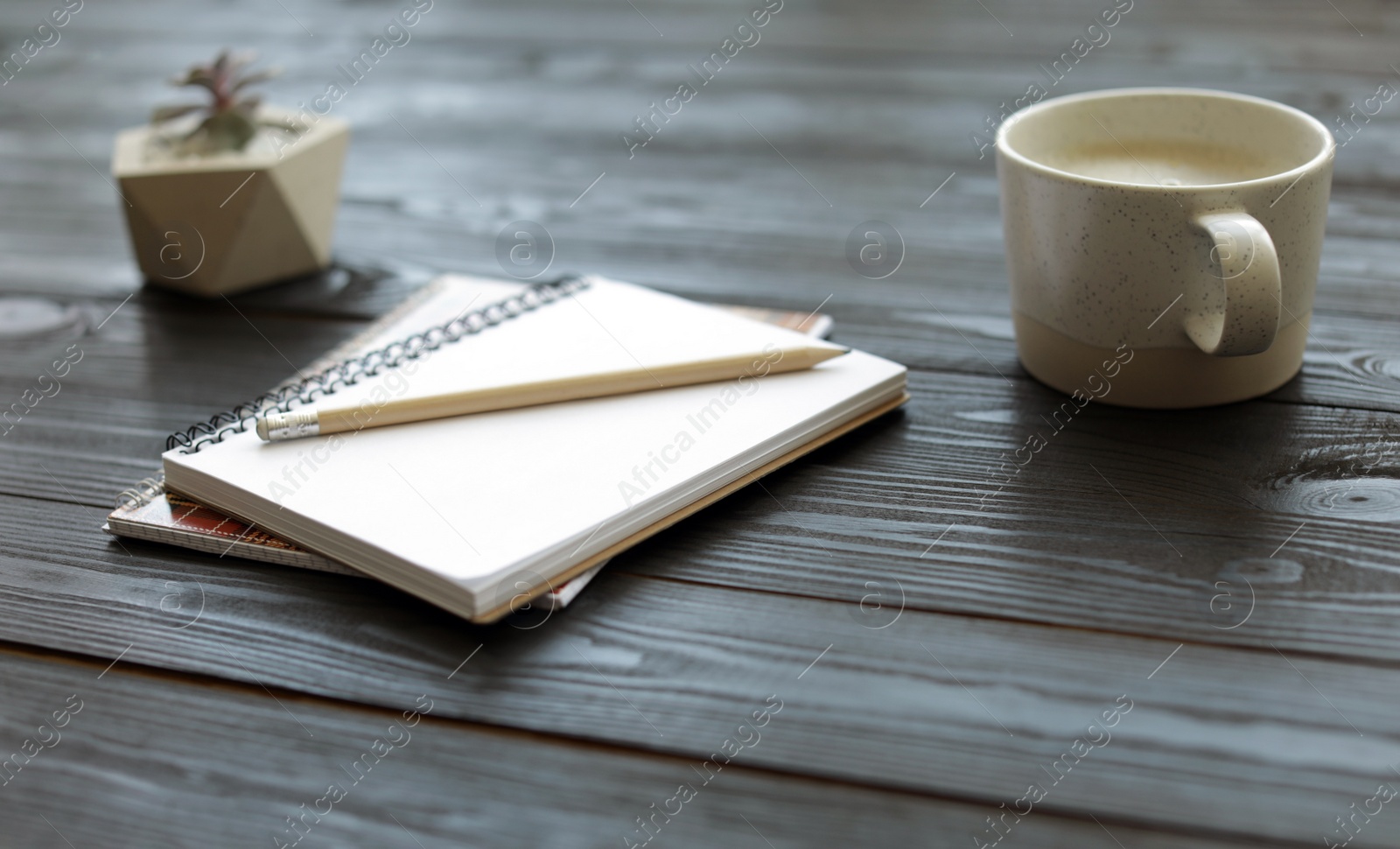 Photo of Composition with office stationery and cup of coffee on wooden table