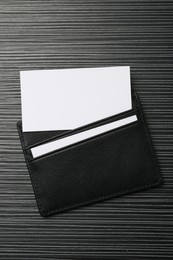 Leather business card holder with blank cards on grey table, top view