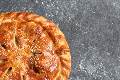 Photo of Tasty homemade pie on grey table, top view. Space for text