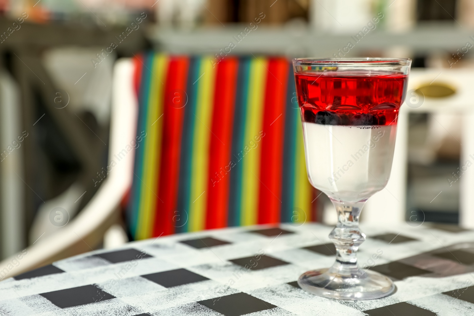 Photo of Delicious panna cotta dessert on table in cafe. Space for text