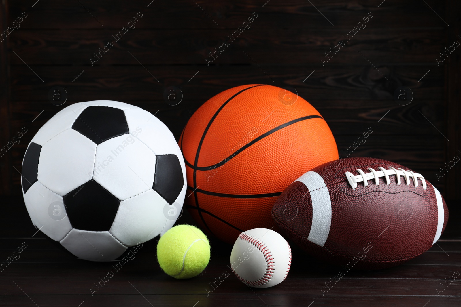 Photo of Set of different sport balls on wooden table