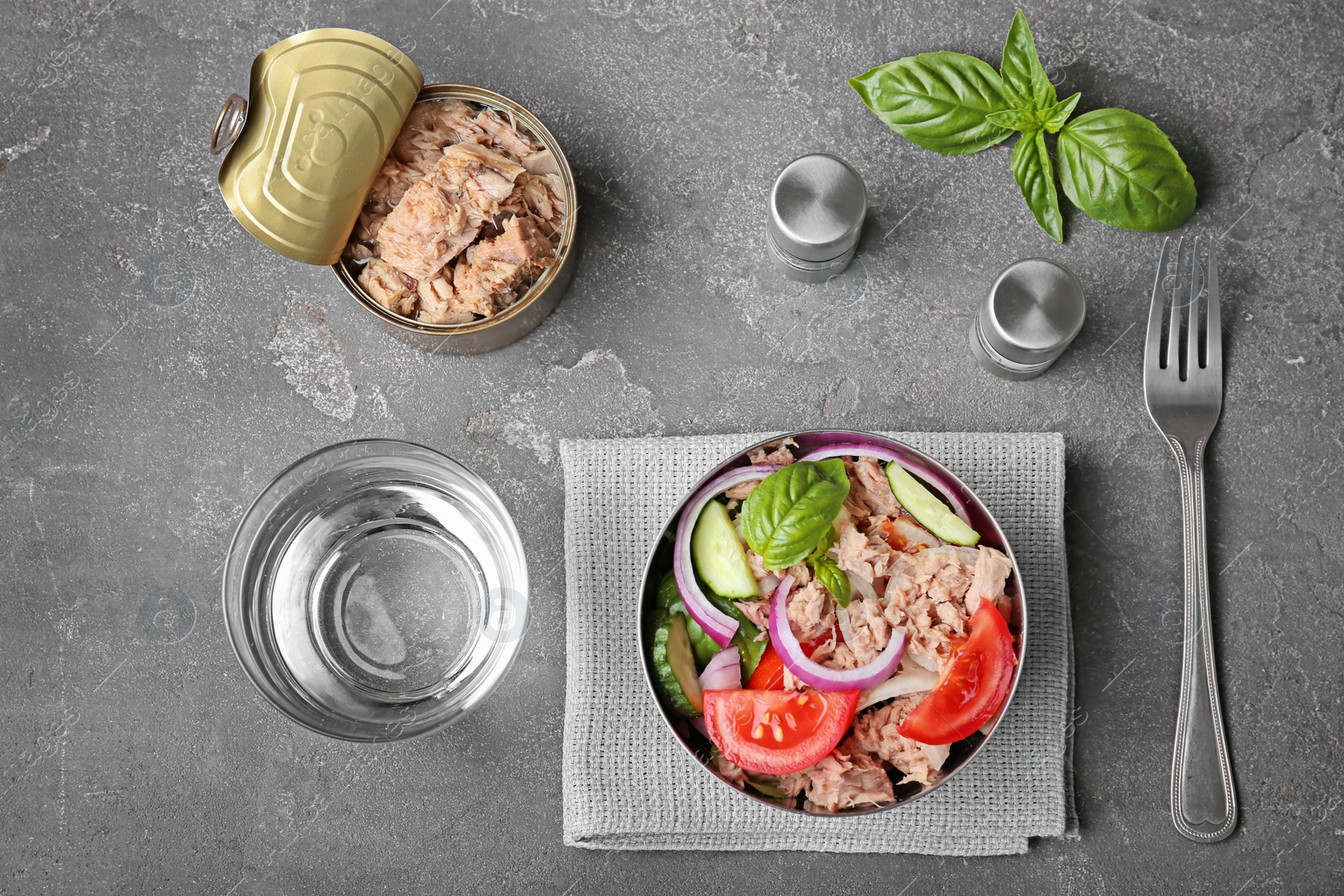 Photo of Flat lay composition with canned tuna and delicious salad on grey background