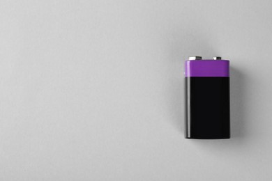 Image of New nine volt battery on light grey background, top view. Space for text