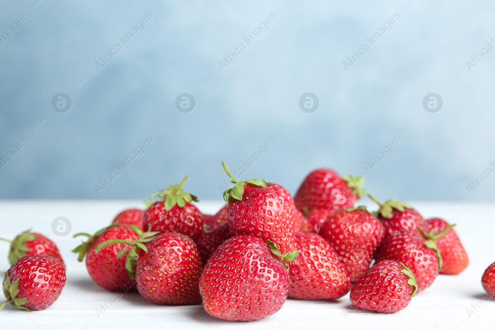 Photo of Delicious ripe strawberries on white table, closeup