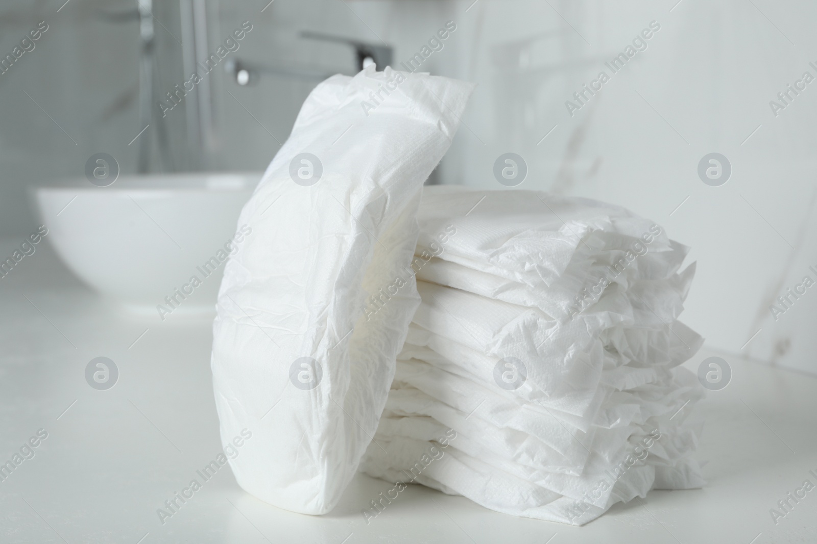Photo of Stack of baby diapers on counter in bathroom