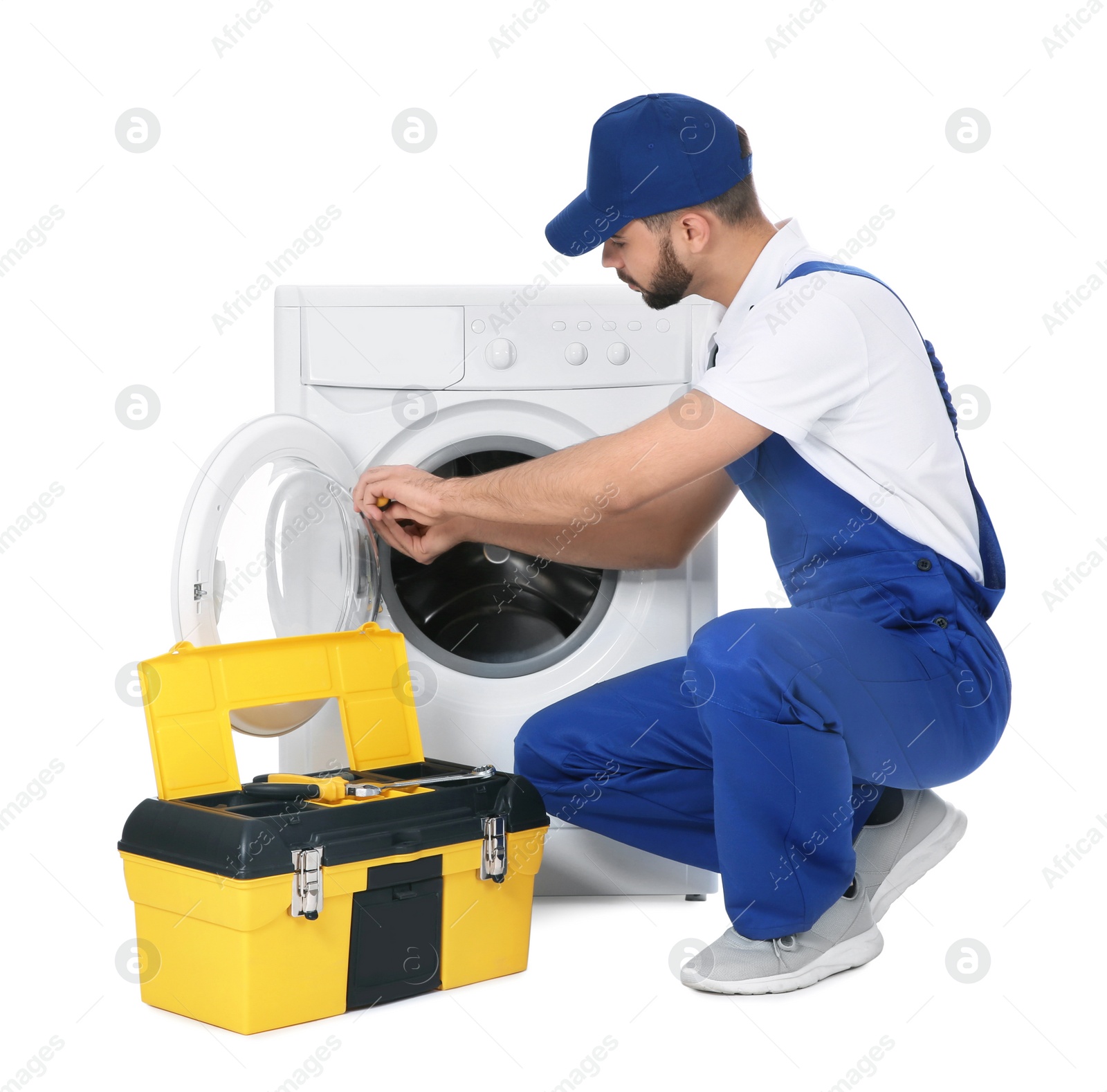 Photo of Plumber repairing washing machine on white background