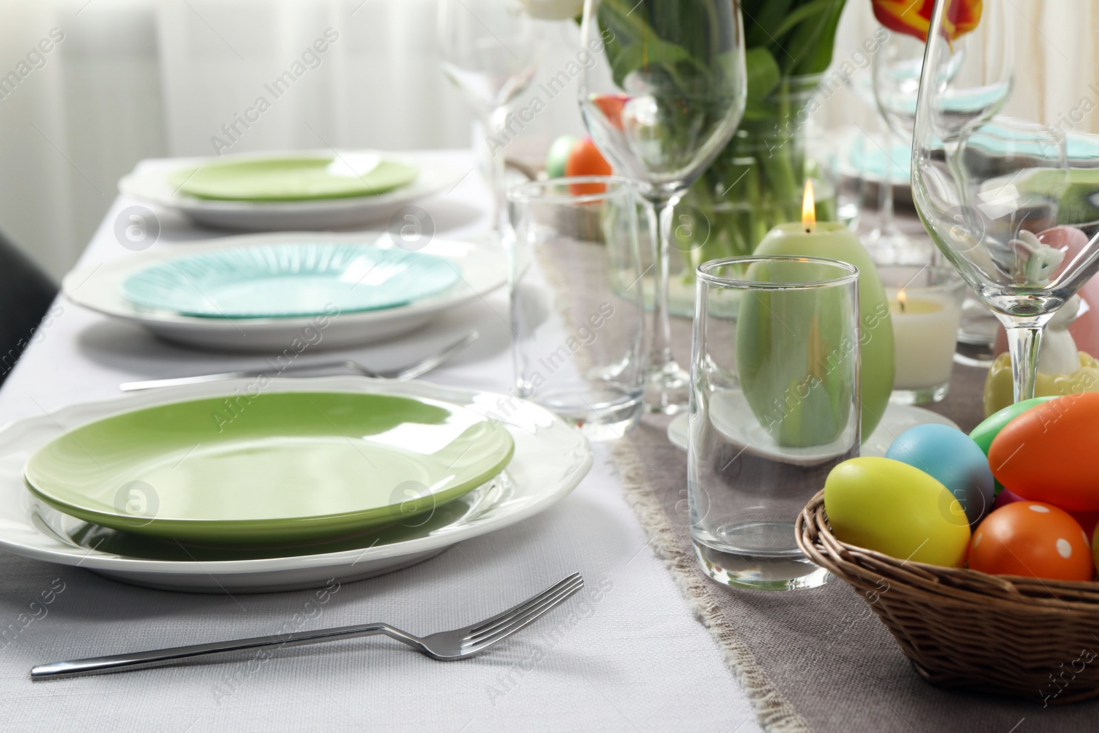 Photo of Easter celebration. Festive table setting with painted eggs