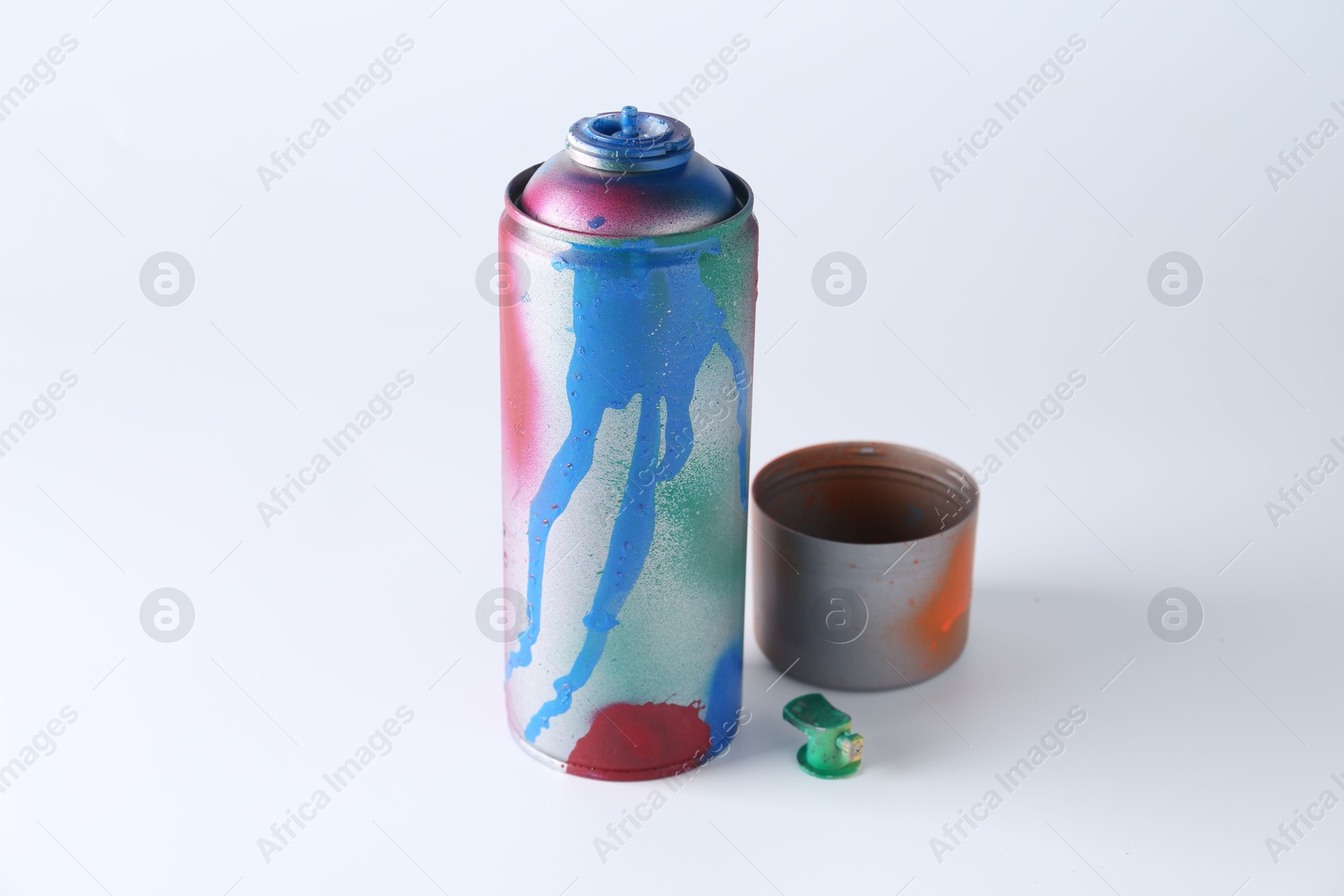 Photo of One spray paint can and cap on white background