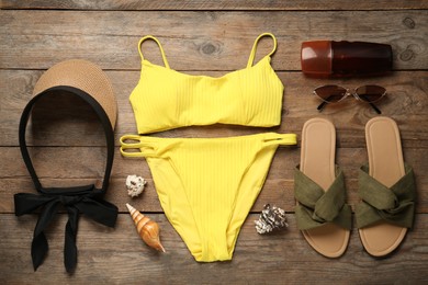 Flat lay composition with beach accessories on wooden background