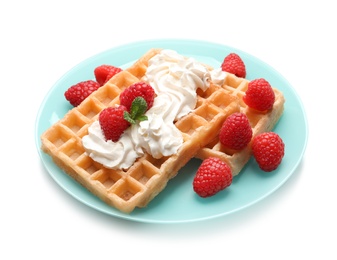 Photo of Plate with yummy waffles, whipped cream and raspberries on white background