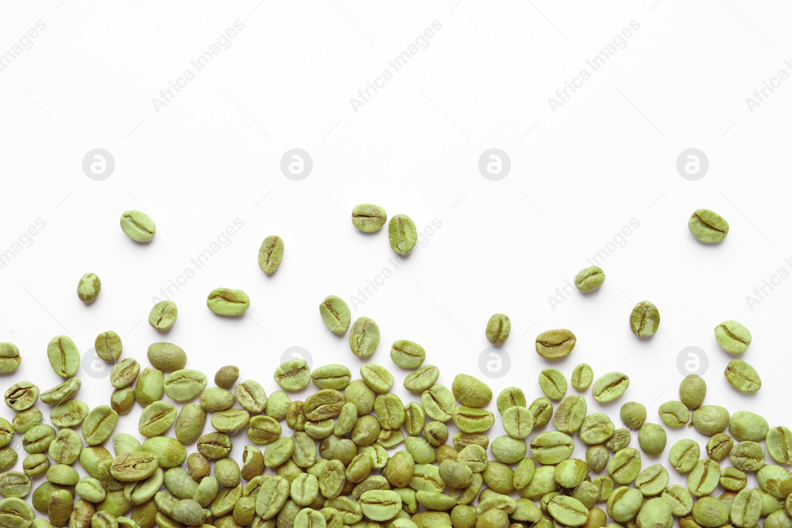 Photo of Many green coffee beans on white background, top view