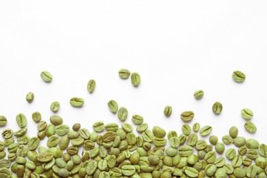 Many green coffee beans on white background, top view