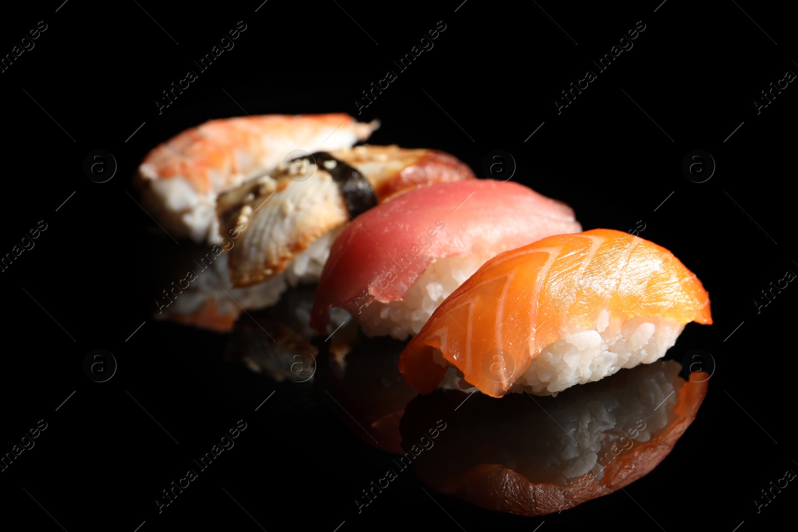 Photo of Delicious nigiri sushi on black background. Traditional Japanese cuisine