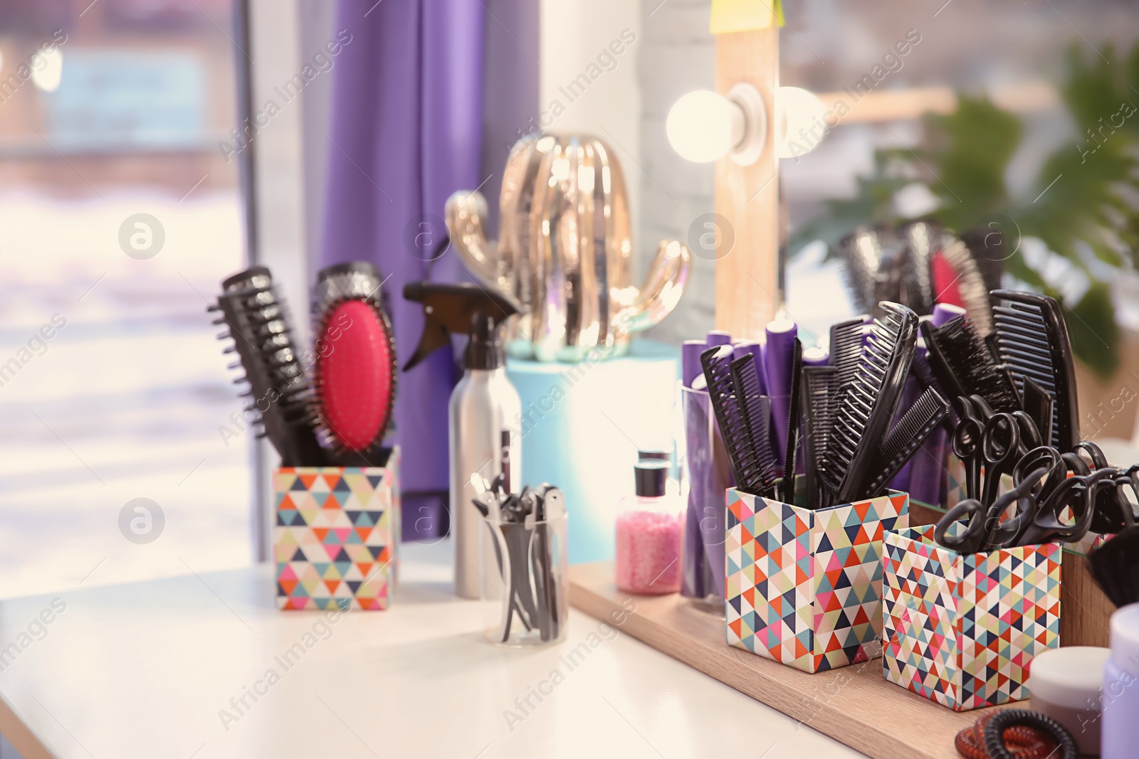 Photo of Set of hairdresser tools on table in salon