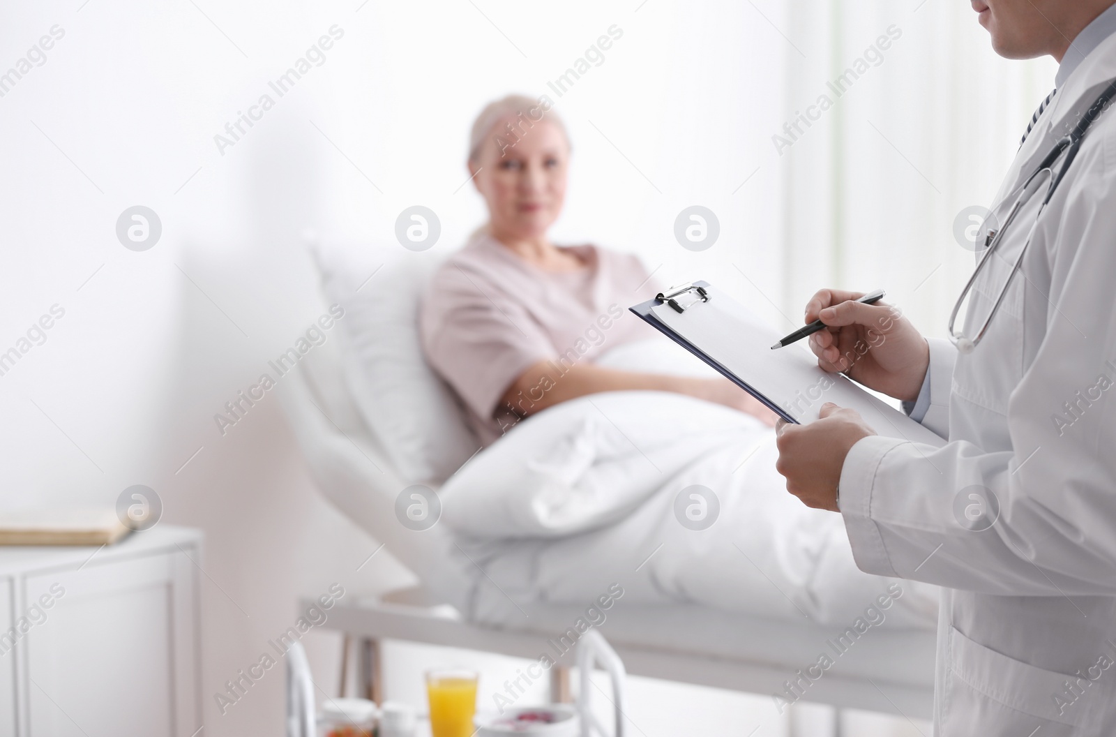 Photo of Doctor visiting his patient in hospital ward, closeup