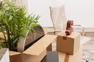 Moving box with office stuff on table indoors, closeup