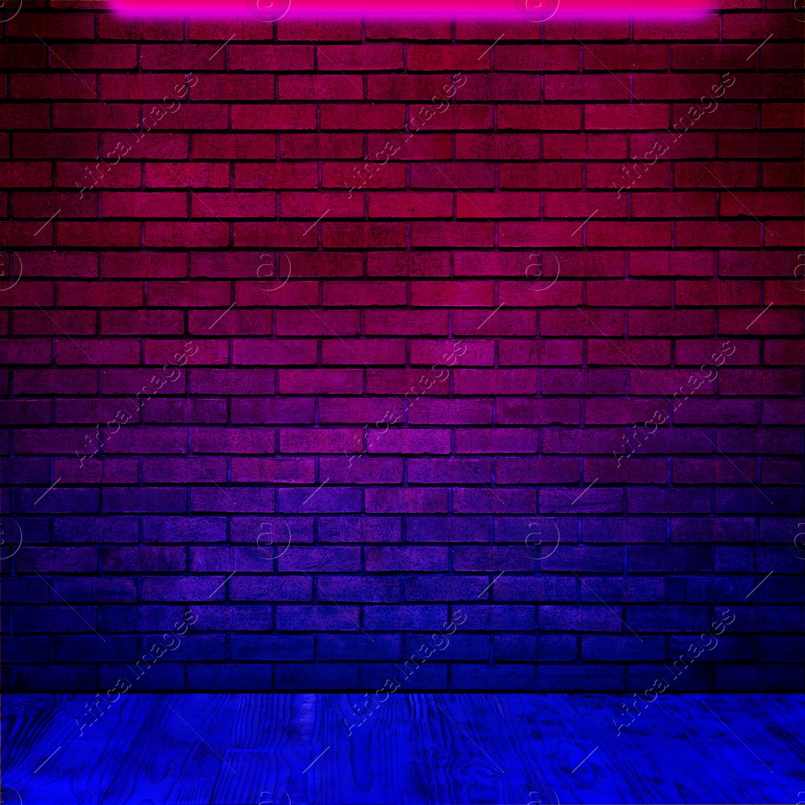 Image of Glowing neon lamp on brick wall in room