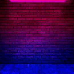 Image of Glowing neon lamp on brick wall in room