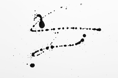 Photo of Blots of black ink on white background, top view