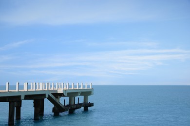 Photo of Beautiful white pier in sea on sunny day, space for text