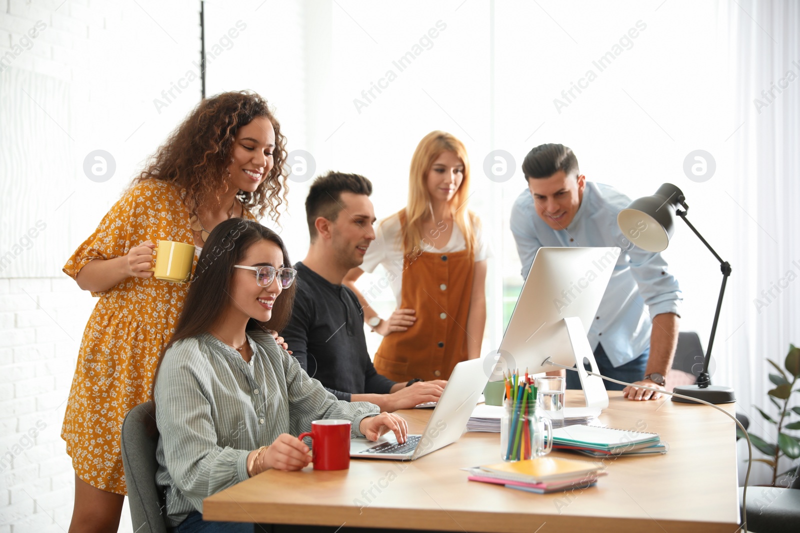 Photo of Team of professional designers working in office