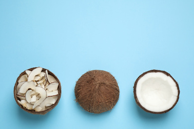 Flat lay composition with tasty coconut chips on light blue background. Space for text