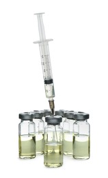 Syringe with vials of medicine on white background