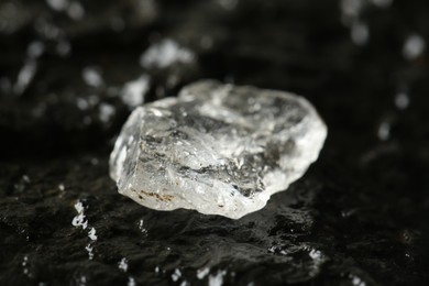 Photo of Shiny rough diamond on stone surface, closeup