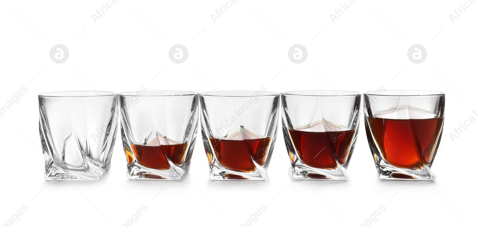 Photo of Empty and full whiskey glasses on white background