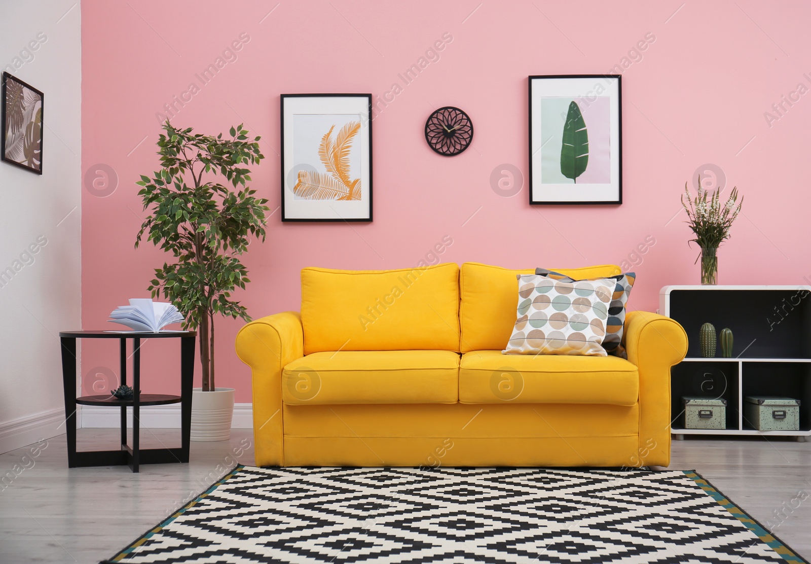 Photo of Modern living room interior with comfortable yellow sofa near color wall