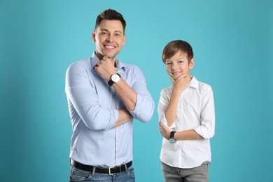 Photo of Portrait of dad and his son on color background