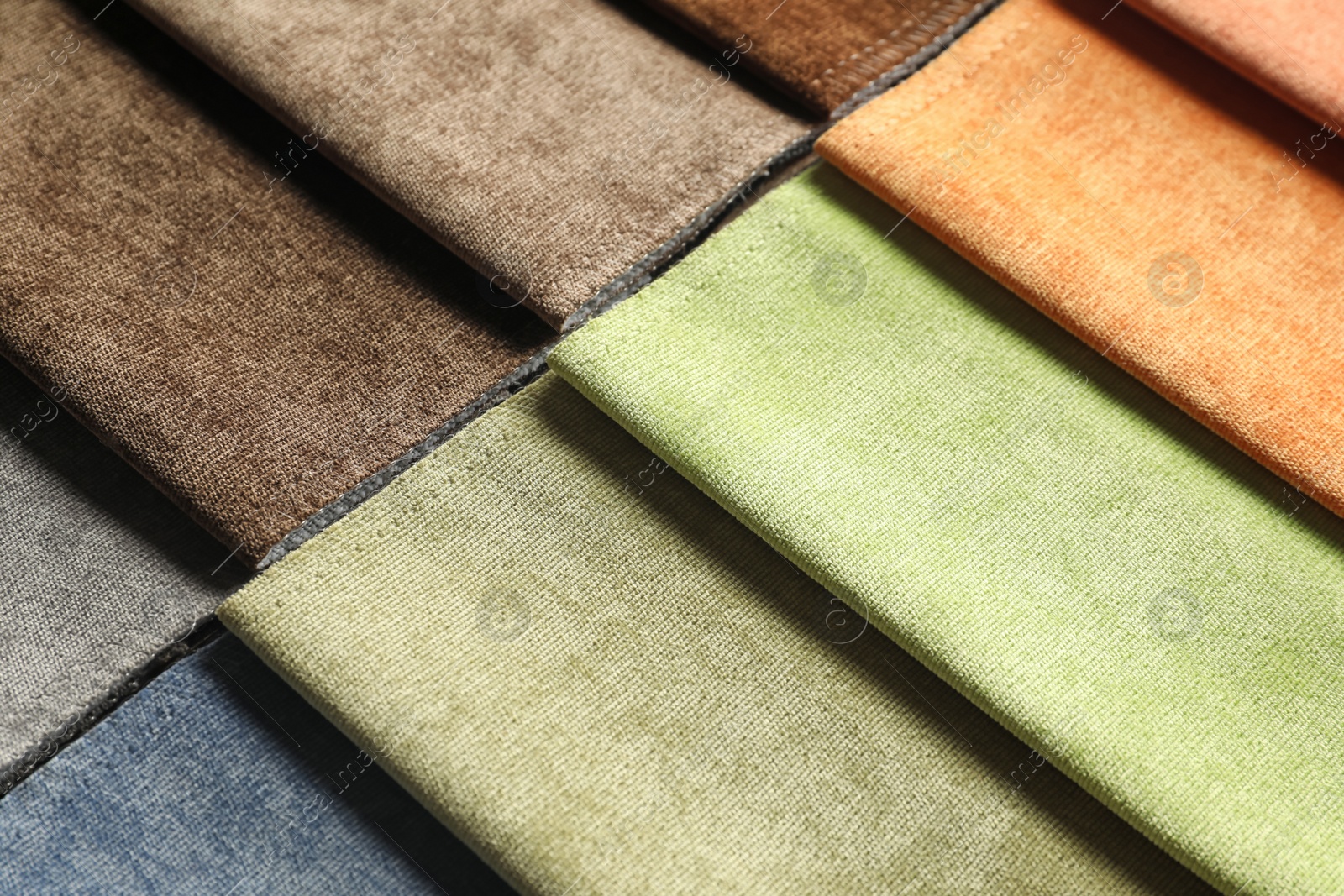 Photo of Fabric samples of different colors for interior design as background