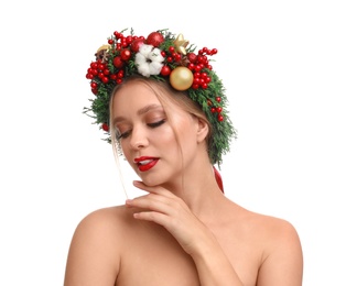 Beautiful young woman wearing Christmas wreath on white background