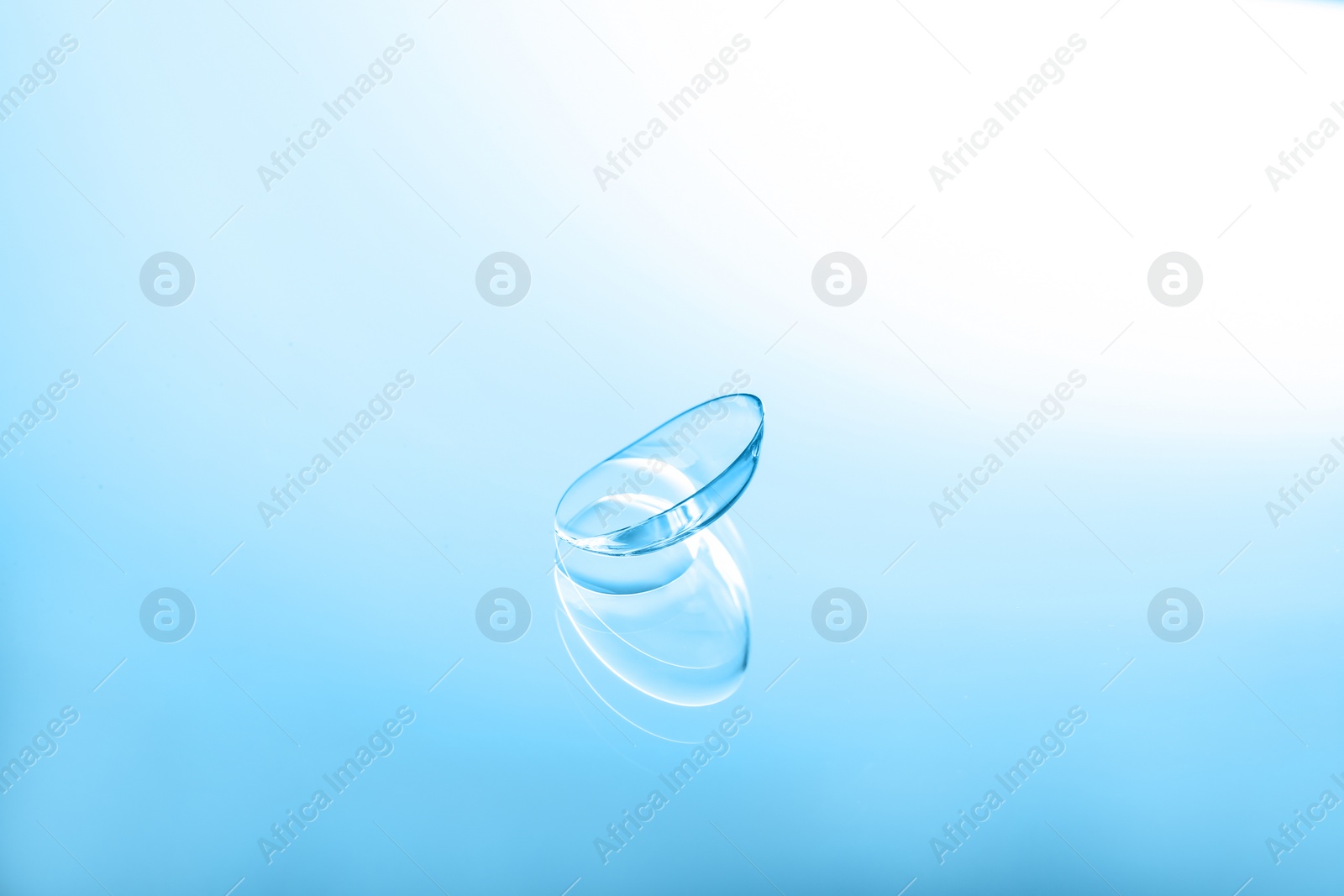 Photo of Contact lens on color glass background