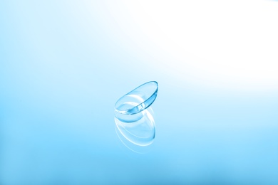 Contact lens on color glass background