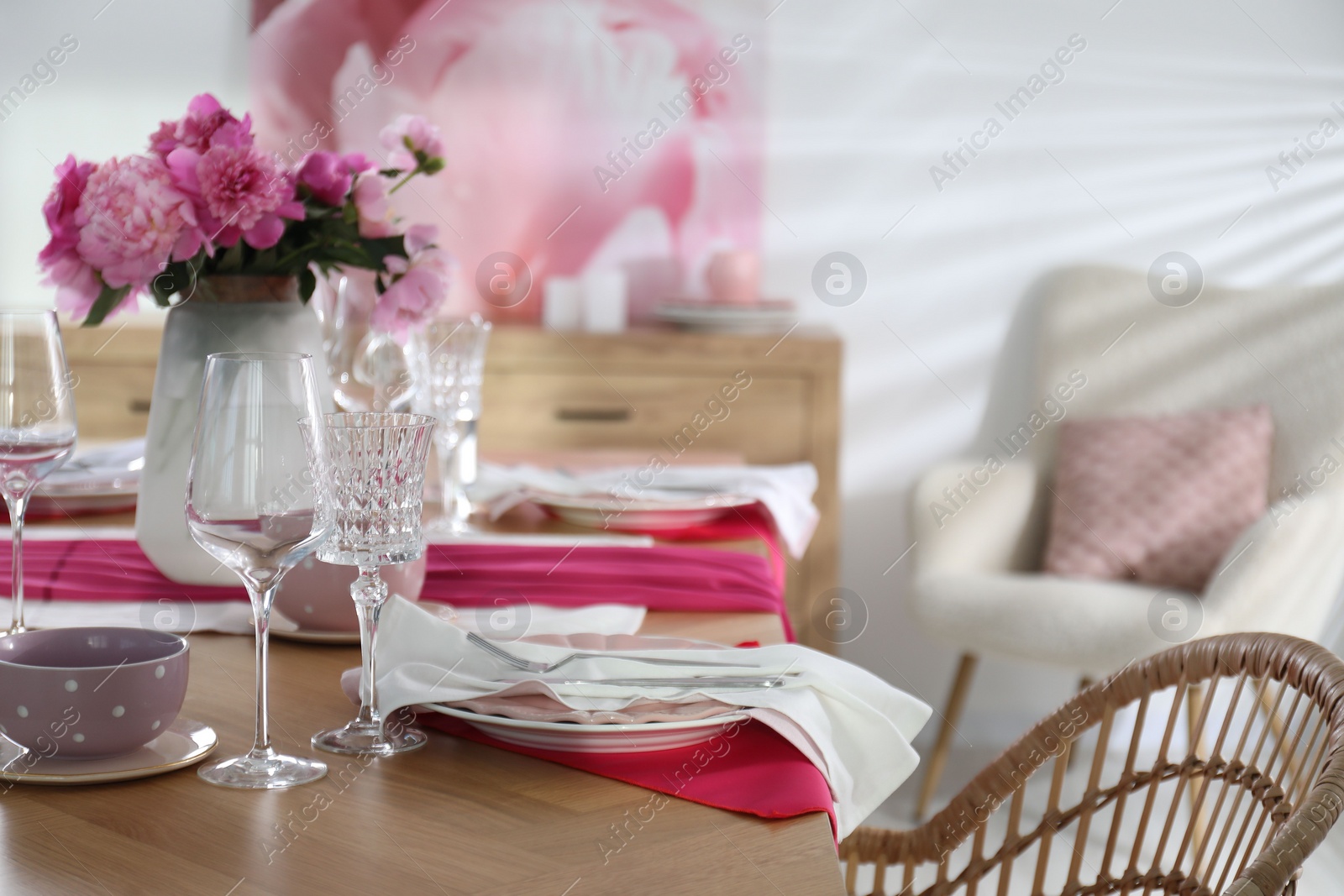 Photo of Beautiful table setting with pink peonies in dining room