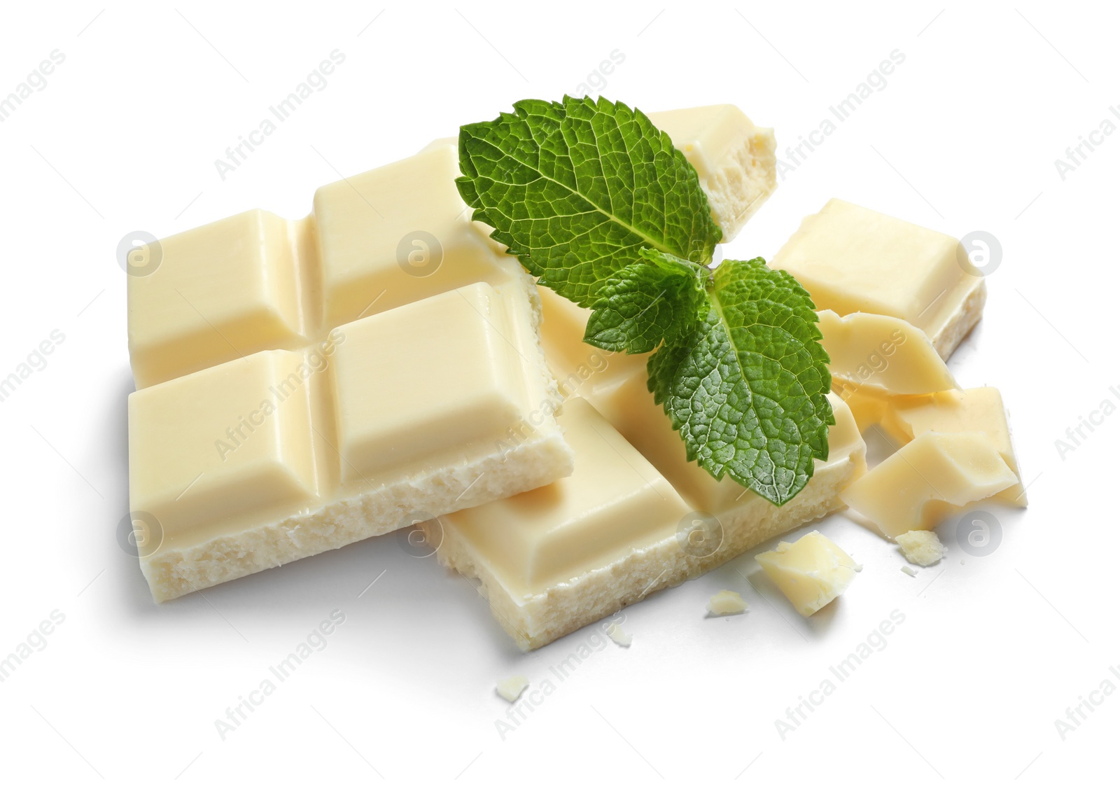 Photo of Pieces of white chocolate with mint on white background