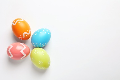 Beautiful painted Easter eggs on white background, top view